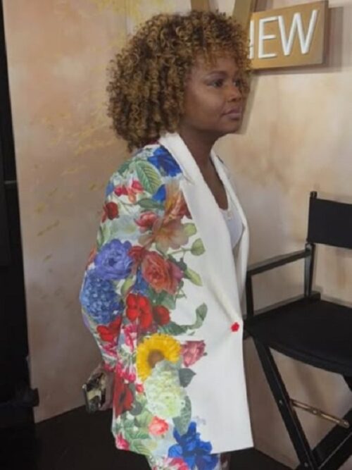 Karine Pierre stuns in The View 2025 White Floral Blazer, a sophisticated piece with a crisp white base and bold, colorful floral-patterned sleeves.