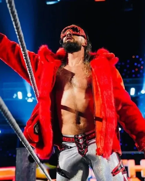 Seth Rollins in a vibrant red jacket and boots, exuding confidence at WWE Monday Night Raw.